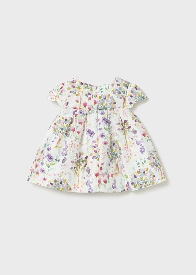 Vestido bebé estampado floral con lazo.