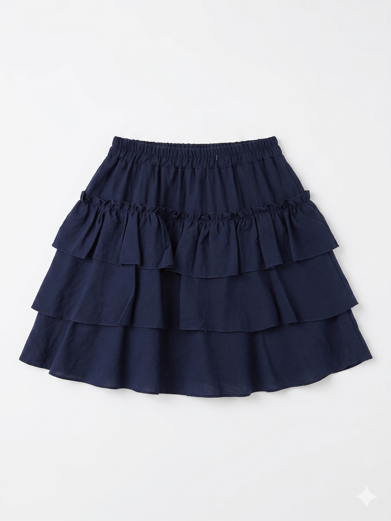Falda corta azul marino con volantes y cintura elástica chica.