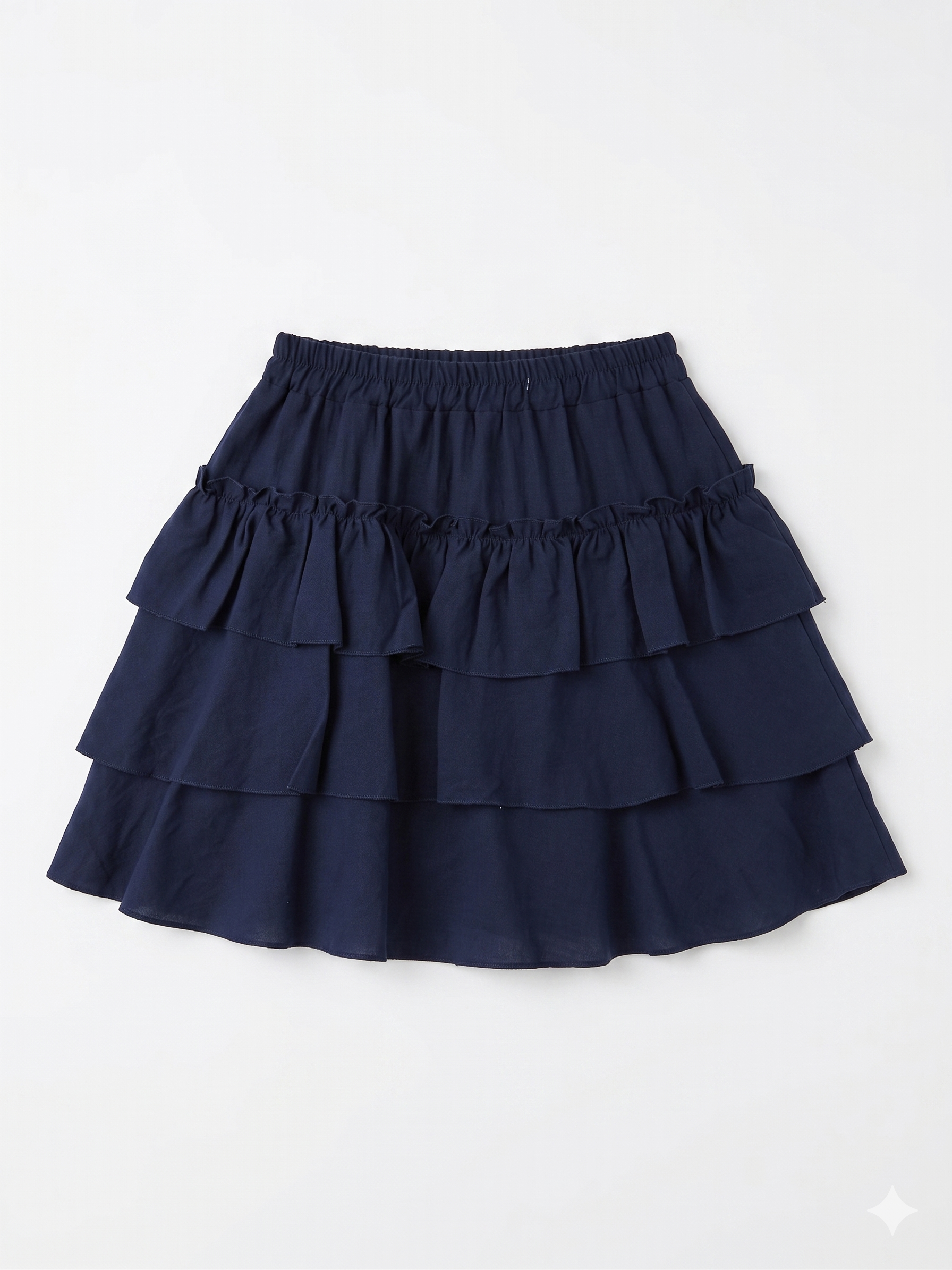 Falda corta azul marino con volantes y cintura elástica chica.