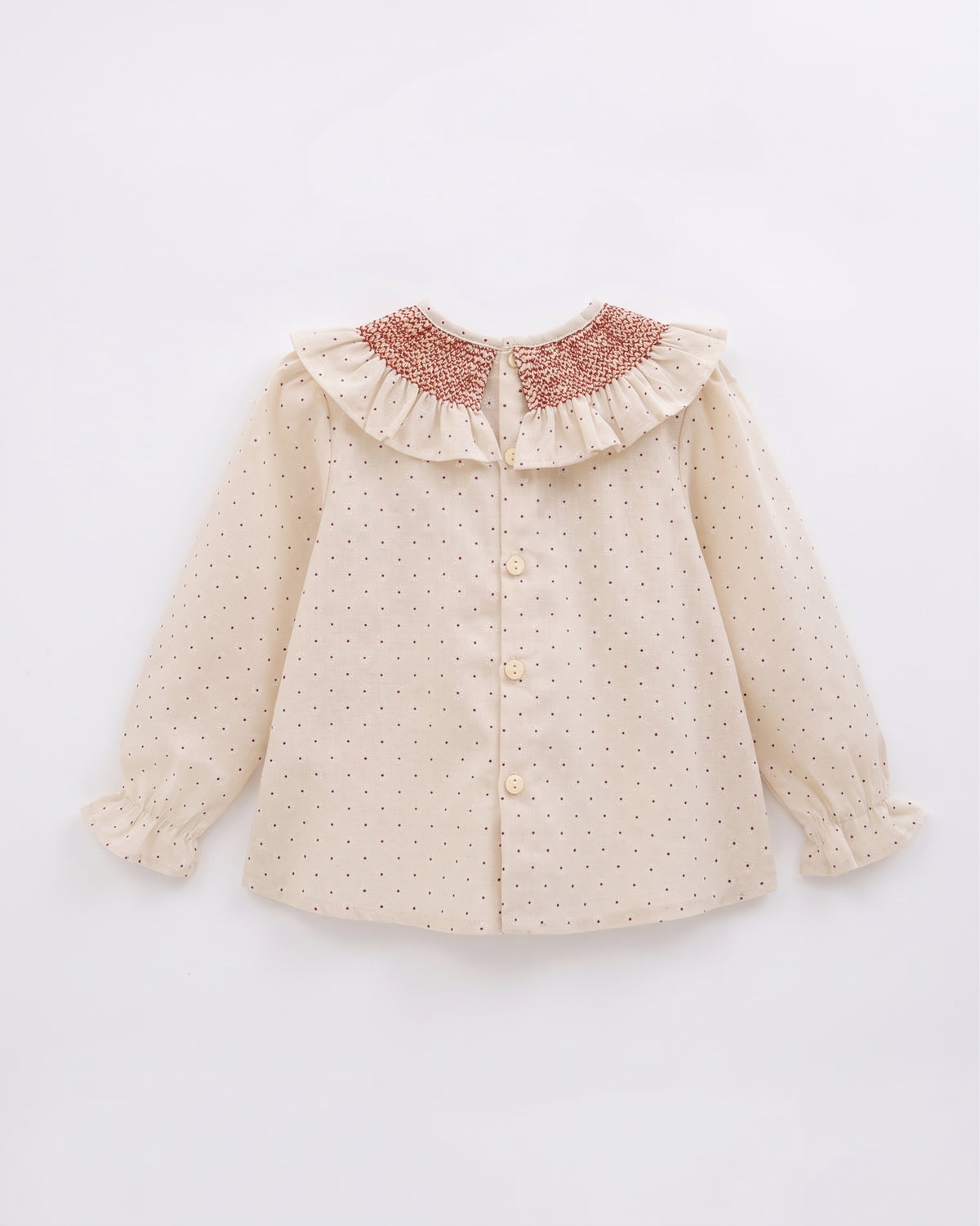 Blusa estampada manga larga cuello nido de abeja y volante bebé y niña.