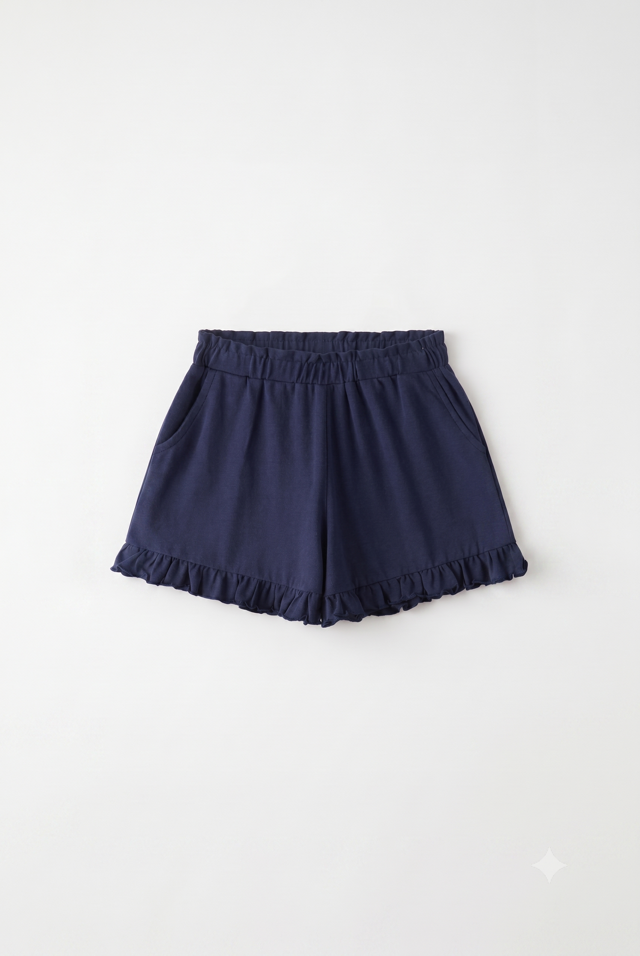Pantalón corto de punto niña con volante.